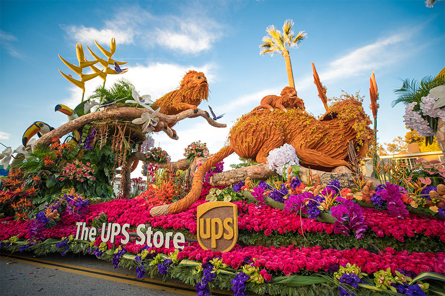 The UPS Store's 2020 Rose Parade float featuring monkeys, birds and flowers